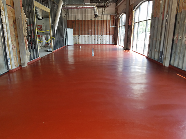 Red, seamless urethane concrete flooring in a brewing facility