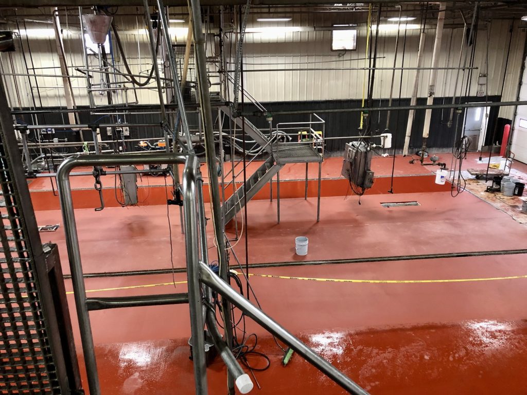 Red Flow Resin Flowfresh HF industrial flooring installed in an Iowa truck tank wash facility. 